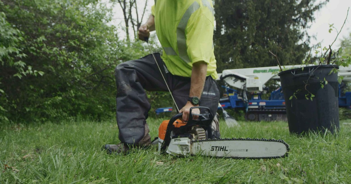 Emergency tree removal specialist using chainsaw on fallen tree in Laredo, TX